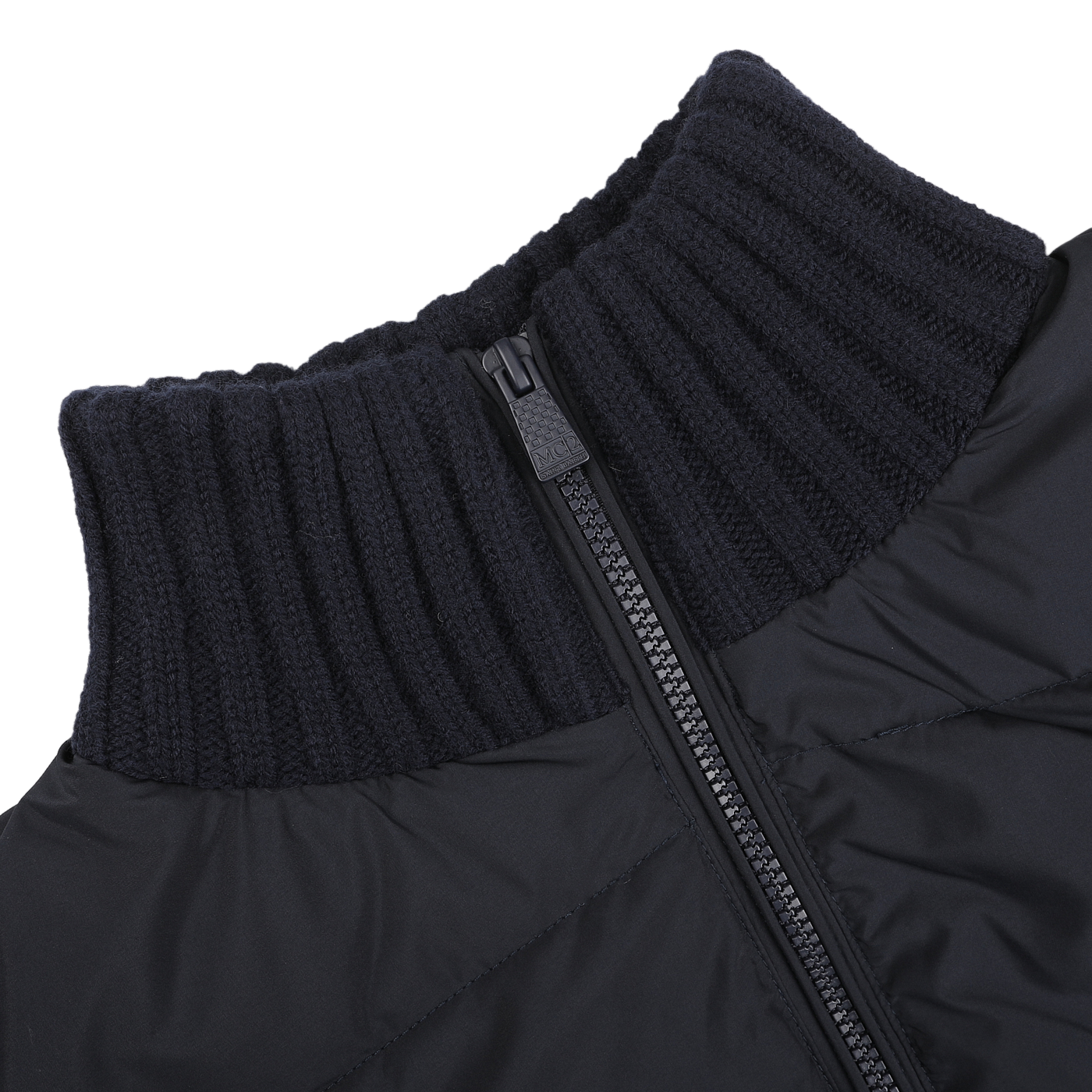 Close-up of a navy blue padded jacket by MC2 Saint Barth, featuring a wool finish, ribbed high collar, and a partially unzipped zipper.