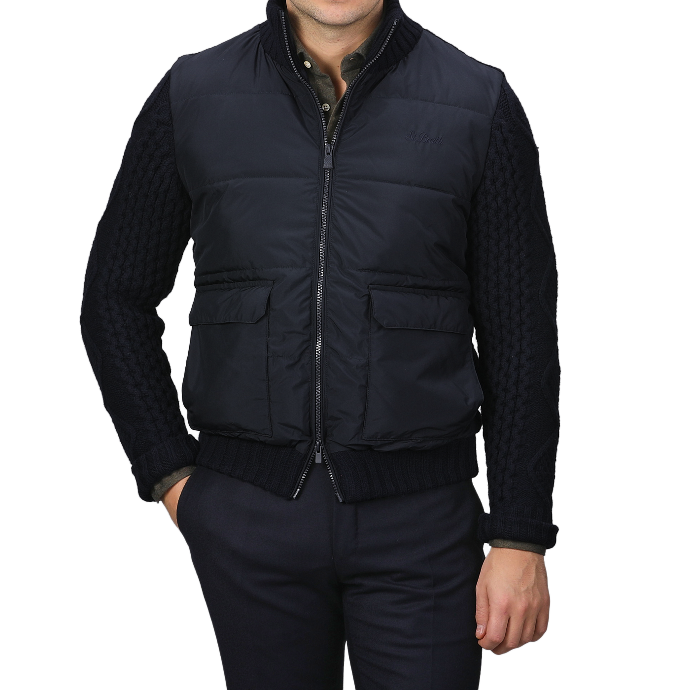 A person wearing a Navy Blue Wool Whistler Padded Jacket by MC2 Saint Barth, paired with dark trousers, stands against a plain background.