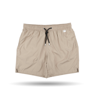 The Safari Beige Pantone 15-1116 Swim Shorts by MC2 Saint Barth are crafted from quick-drying fabric and feature an elastic waistband with side pockets, showcased against a white background.