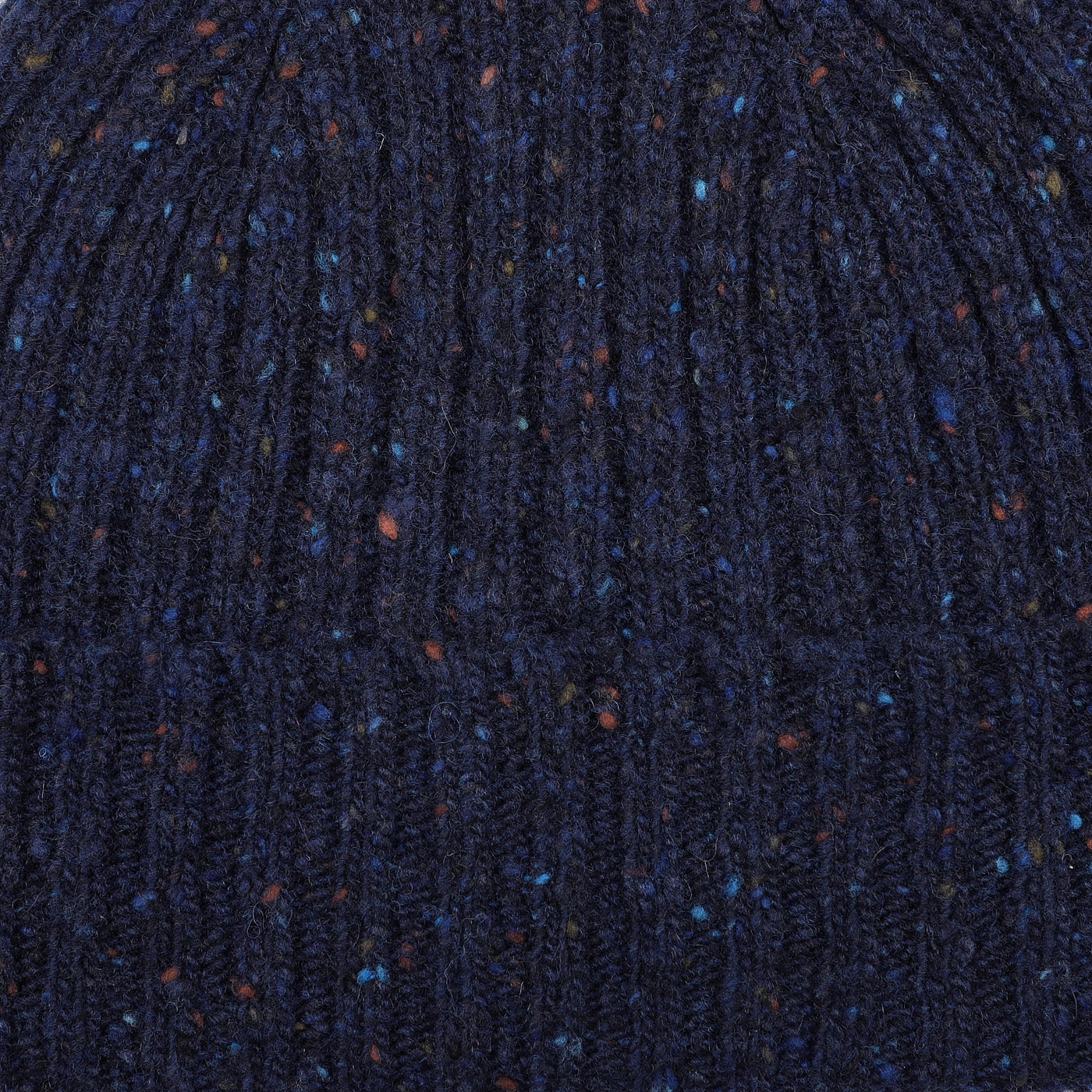 Close-up of a Mackie Navy Blue Melange Wool Donegal Beanie, showcasing its textured knit with speckles of orange and blue.