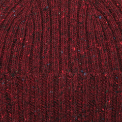 Close-up of the Red Melange Wool Donegal Beanie by Mackie, highlighting the multicolored flecks and intricate stitch detail typical of Scottish knitwear.