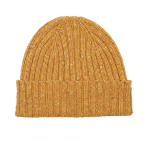 The Yellow Melange Wool Donegal Beanie by Mackie, featuring a folded brim and crafted from pure wool, sits elegantly on a white background.