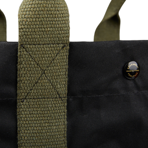 A close up of a Manifattura Ceccarelli Black Waxed Cotton Tote Bag with canvas details in a dark green shade.