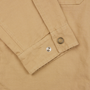 A close up of a Camel Beige Cotton Ripstop Country Overshirt from Manifattura Ceccarelli with buttons.