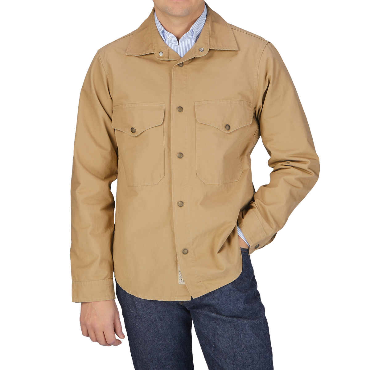 A man wearing a Camel Beige Cotton Ripstop Country Overshirt by Manifattura Ceccarelli and jeans.