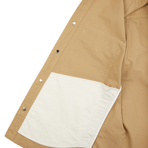 The back of a Camel Beige Cotton Ripstop Country Overshirt with a white pocket from Manifattura Ceccarelli.