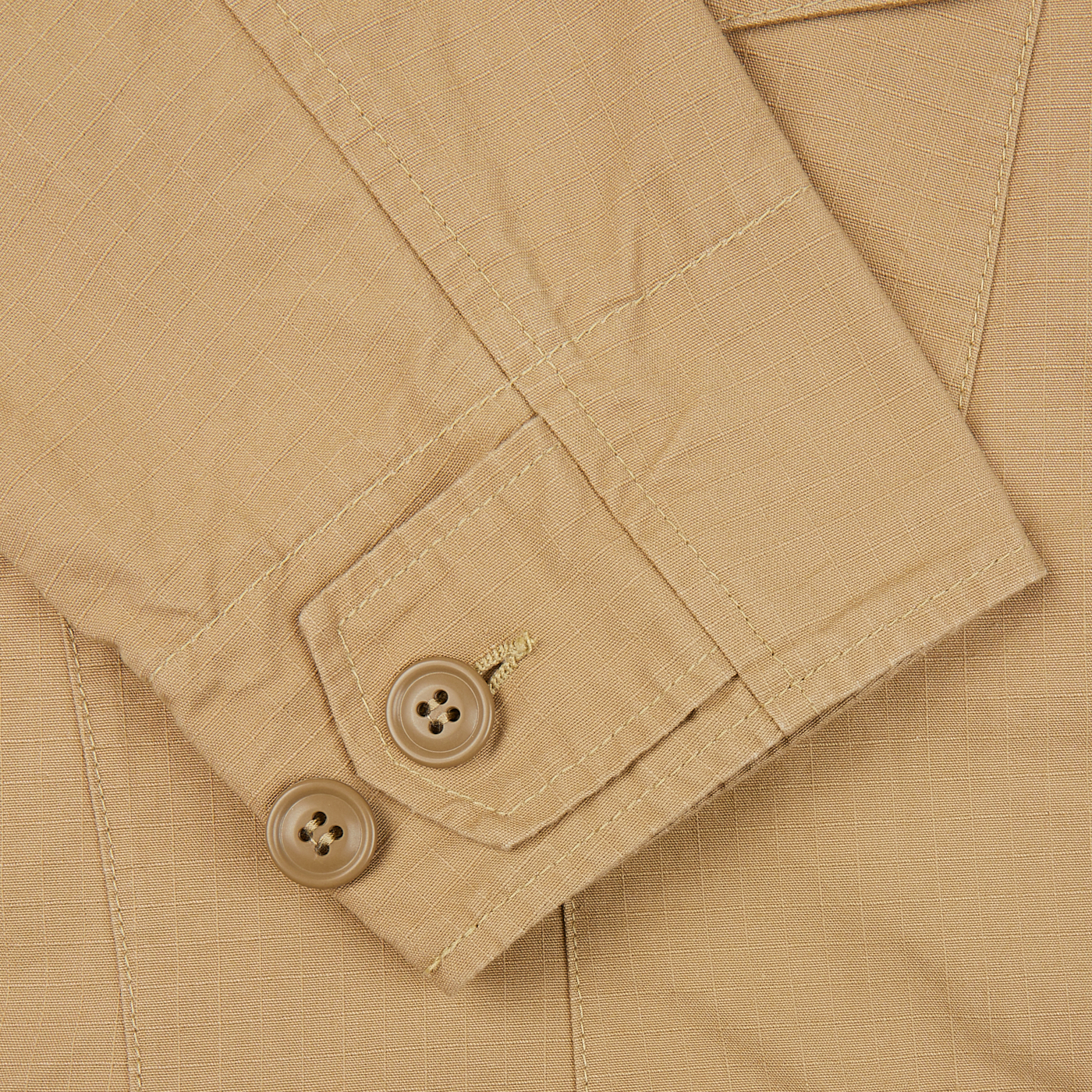 A close up of a Camel Beige Ripstop Cotton Bush Jacket by Manifattura Ceccarelli with buttons made from ripstop cotton.