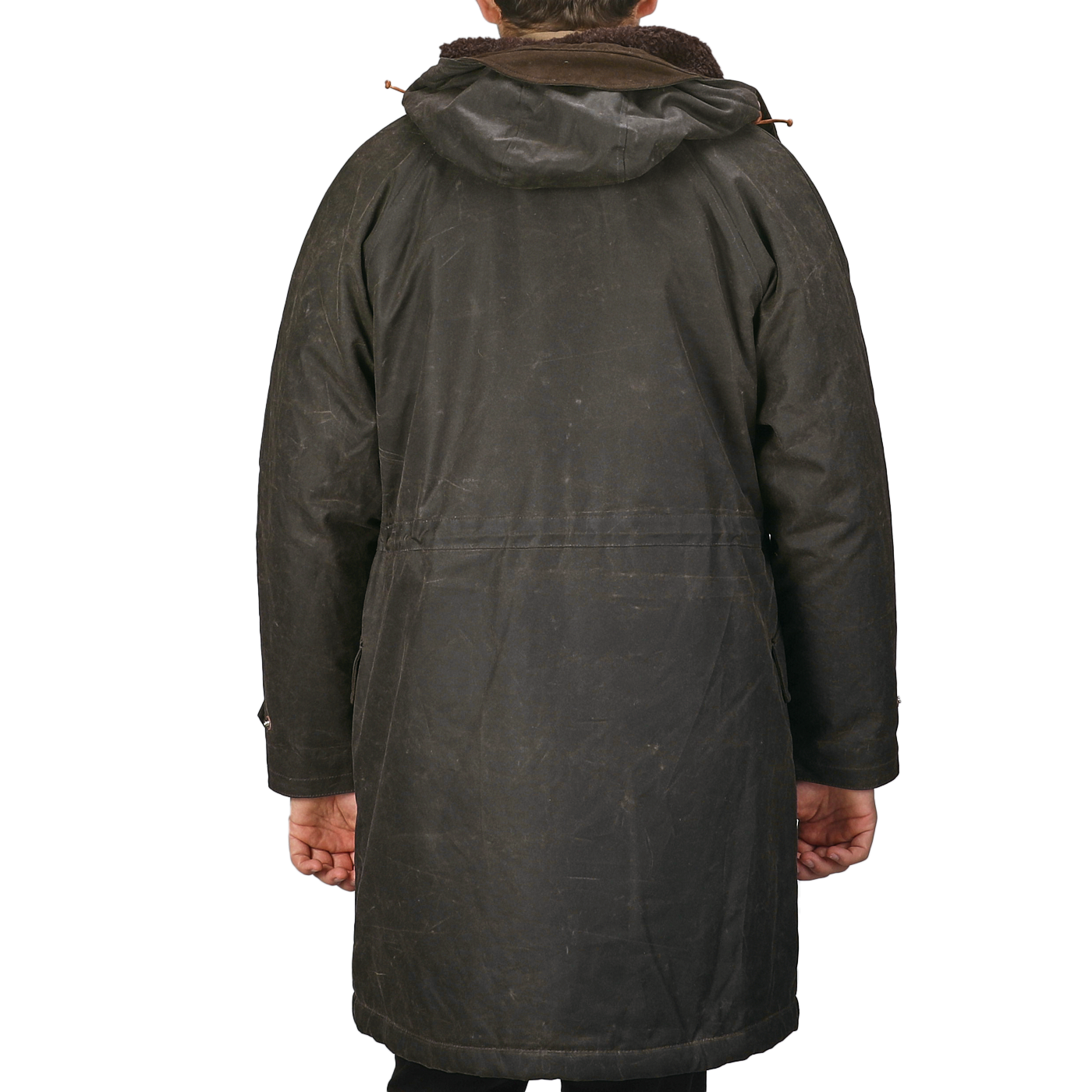 Back view of a person wearing the Dark Green Waxed Cotton Mountain Parka with hood and wool padding by Manifattura Ceccarelli.