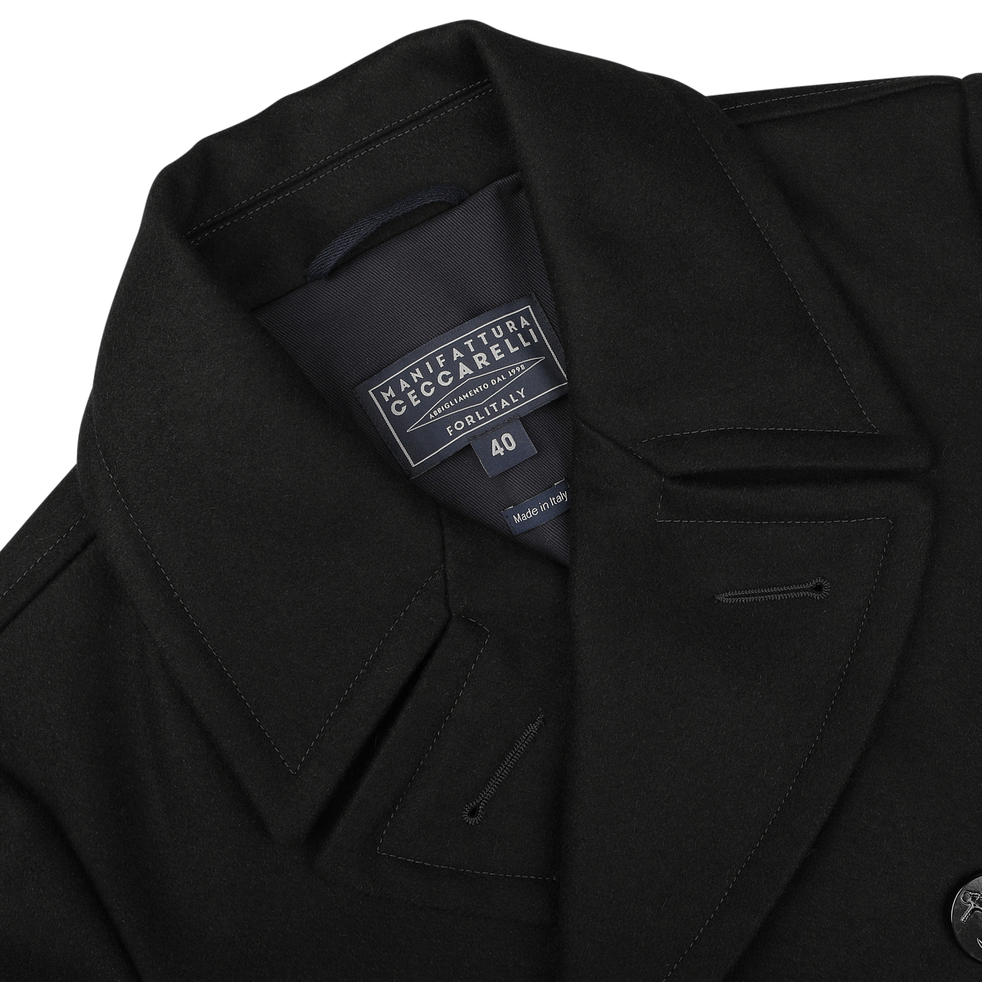 A close-up of the Dark Navy Heavy Wool Peacoat reveals the label "Manifattura Ceccarelli Forli Italy 40" sewn inside the collar, showcasing its high-quality heavy wool blend.