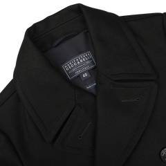 A close-up of the Dark Navy Heavy Wool Peacoat reveals the label "Manifattura Ceccarelli Forli Italy 40" sewn inside the collar, showcasing its high-quality heavy wool blend.