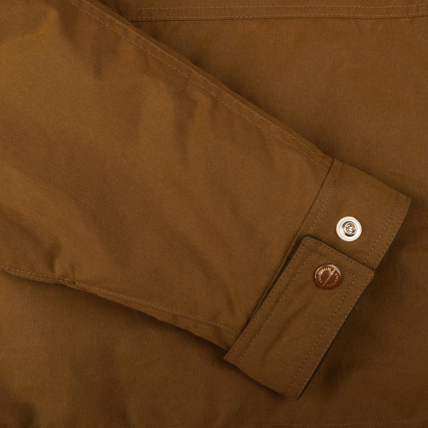 A close up of a Dark Tan Cotton Canvas Fisherman Parka jacket with buttons made in Italy by Manifattura Ceccarelli.