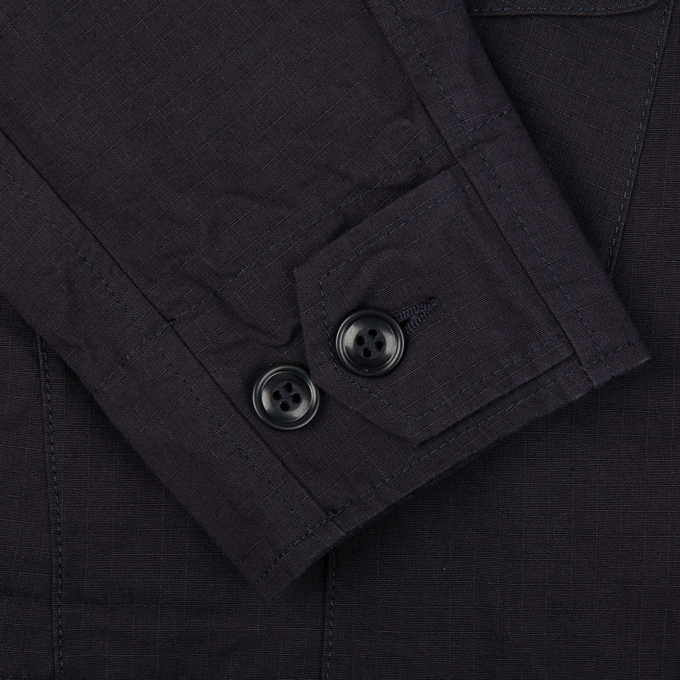 A close up of a Manifattura Ceccarelli Navy Blue Ripstop Cotton Bush Jacket with buttons made of ripstop cotton.