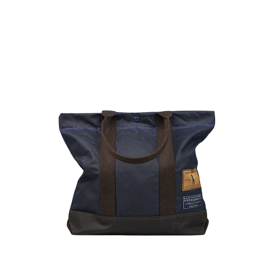 A Navy Blue Waxed Cotton Tote Bag with Brown Handles by Manifattura Ceccarelli.