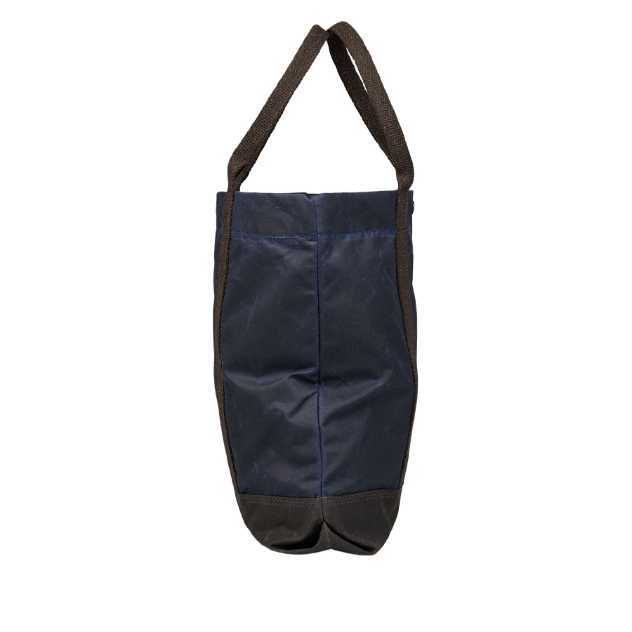 A Navy Blue Waxed Cotton Tote Bag with brown handles by Manifattura Ceccarelli.