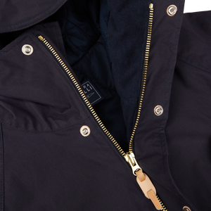 A close up of a Navy Blue Cotton Canvas Fisherman Parka made by Manifattura Ceccarelli with gold zippers, handmade in Italy.