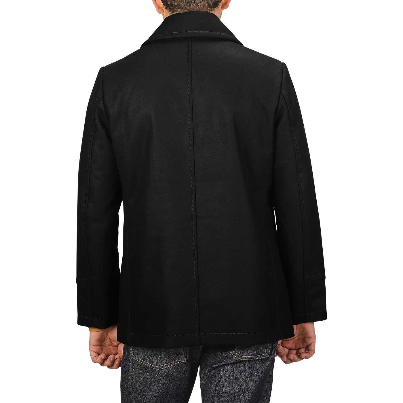 Rear view of a person wearing the Dark Navy Heavy Wool Peacoat by Manifattura Ceccarelli, crafted from a heavy wool blend, and jeans, standing against a plain background.