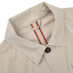 Close-up of Manto's Khaki Beige Ultrafine Microfibre Safari Jacket, a slim-fit with a dark button and red-striped inner tab detail.