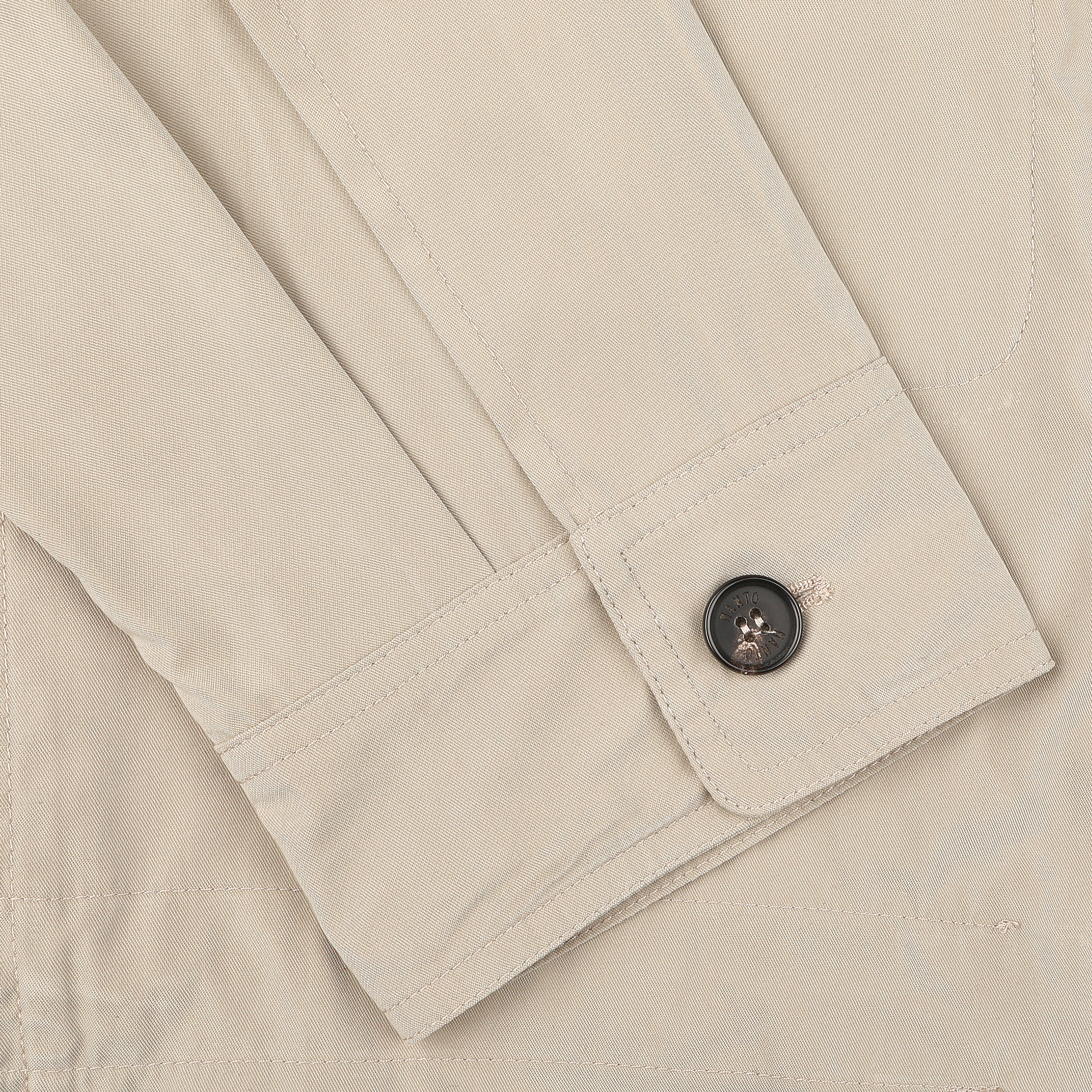 Close-up of the sleeve from Manto's Khaki Beige Ultrafine Microfibre Safari Jacket, showcasing a sleek black button.