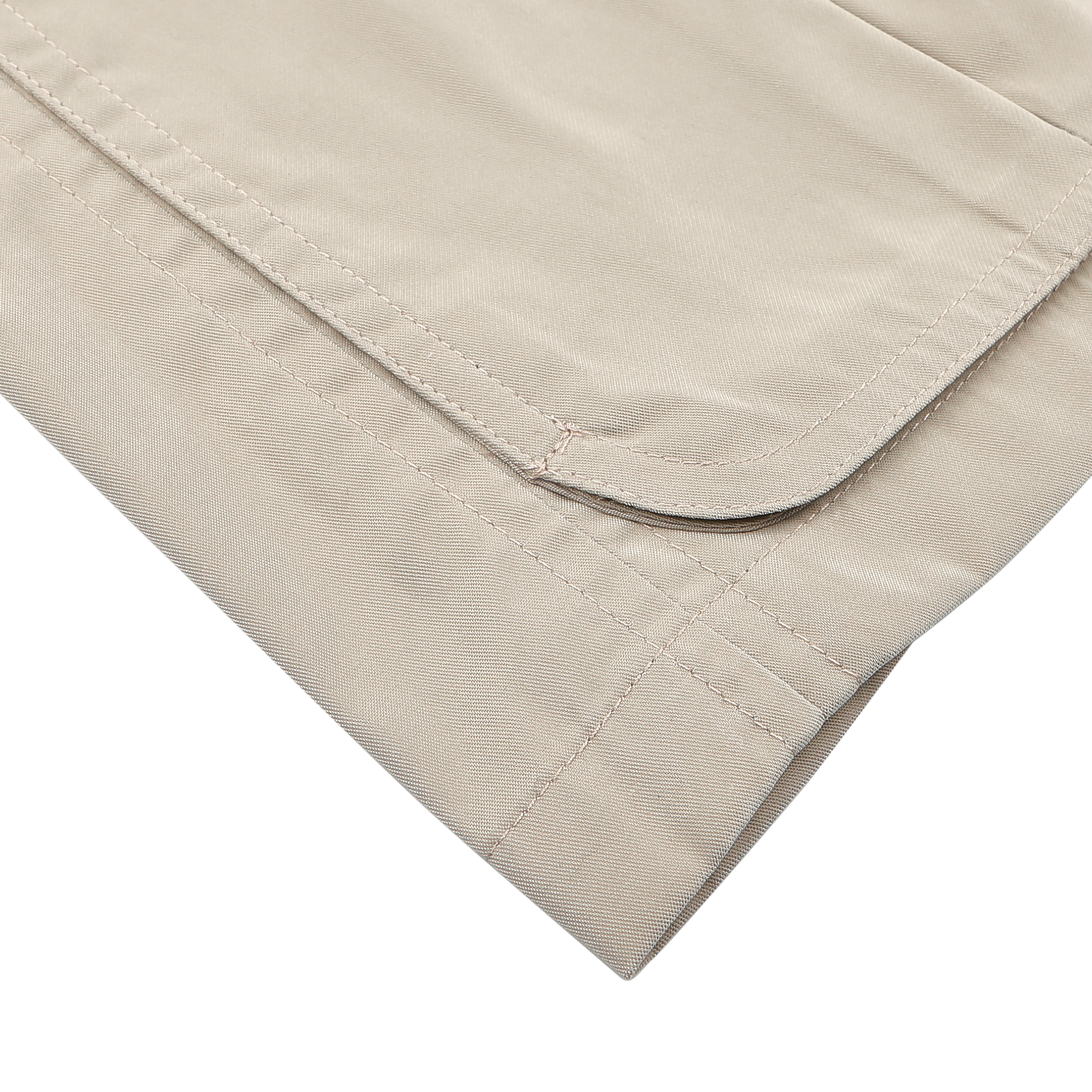 Close-up of a neatly folded Manto Khaki Beige Ultrafine Microfibre Safari Jacket, showing visible stitching, set against a white background.