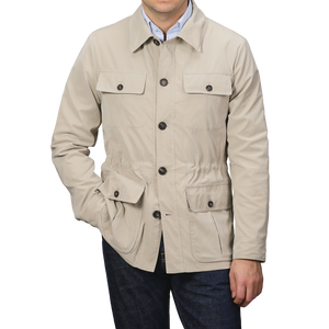 A person wearing a Manto Khaki Beige Ultrafine Microfibre Safari Jacket with button closures and multiple pockets, paired with dark jeans.