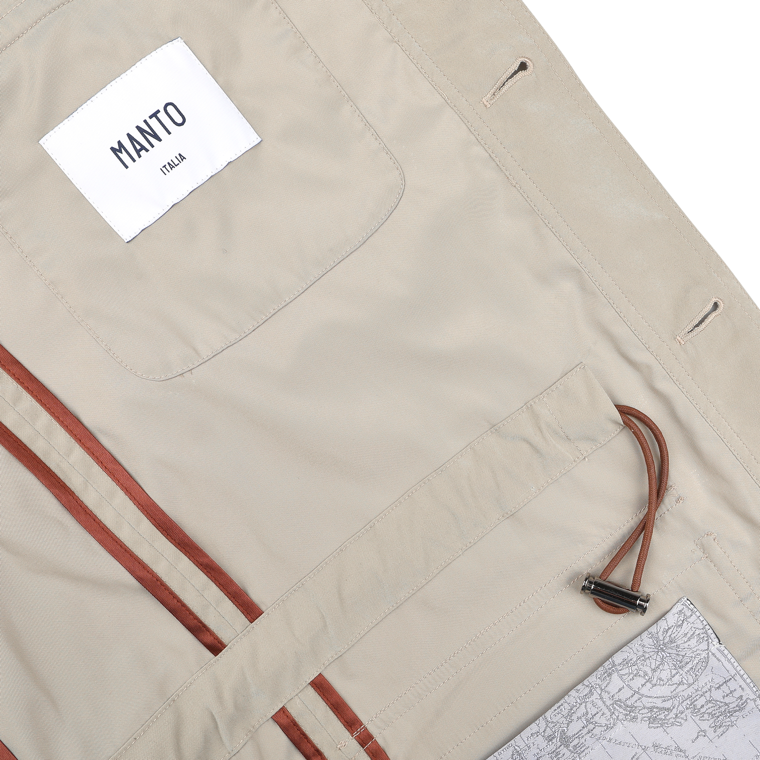 This Khaki Beige Ultrafine Microfibre Safari Jacket by Manto features a leather-trimmed interior, a MANTO label, a metal hook strap, and a soft map pattern. Its slim fit ensures both style and comfort.