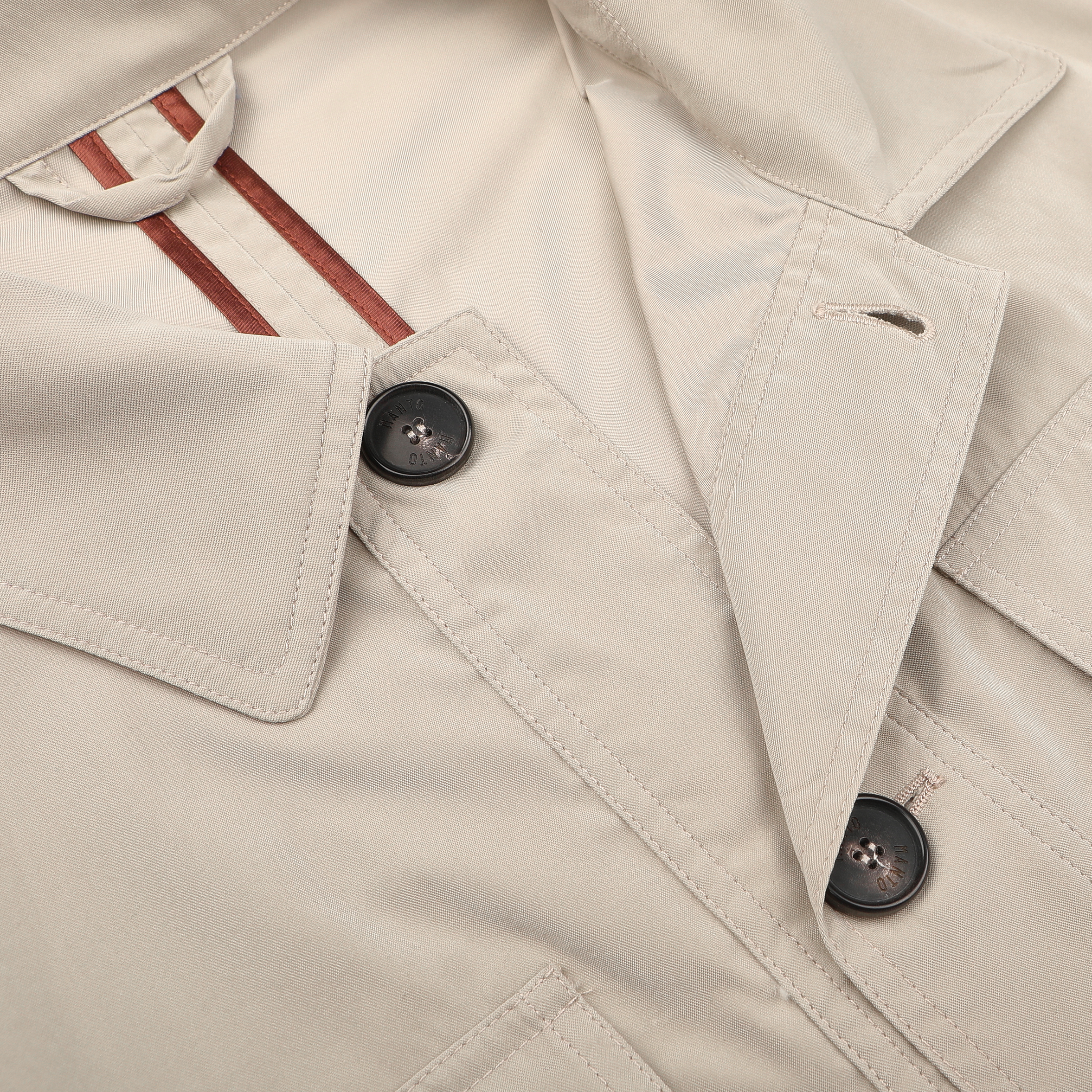 Close-up of Manto's Khaki Beige Ultrafine Microfibre Safari Jacket, a slim fit with two black buttons and a visible red-striped lining.