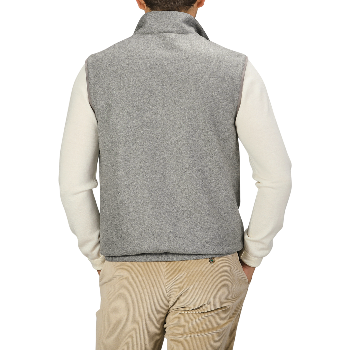 A person wearing a Manto Grey Beige Cashmere Nylon Reversible Gilet over a white long-sleeve shirt and beige corduroy pants stands with their back to the camera.