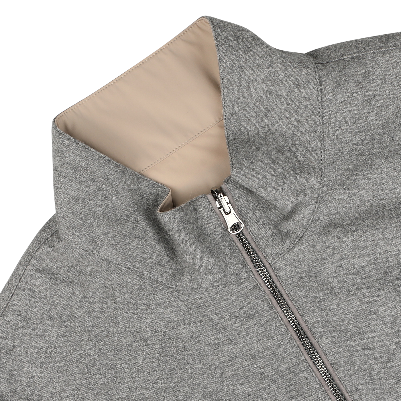 A close-up of the Manto Grey Beige Cashmere Nylon Reversible Gilet, showcasing its luxurious beige lining. The gilet is partially unzipped and lying flat on a light-colored surface.