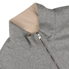 A close-up of the Manto Grey Beige Cashmere Nylon Reversible Gilet, showcasing its luxurious beige lining. The gilet is partially unzipped and lying flat on a light-colored surface.