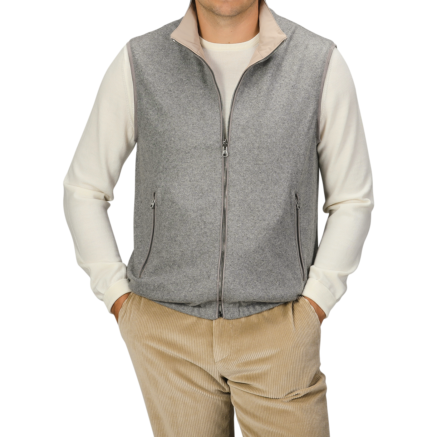 A person wearing a Manto Grey Beige Cashmere Nylon Reversible Gilet over a white long-sleeve shirt and beige corduroy pants stands against a plain background.