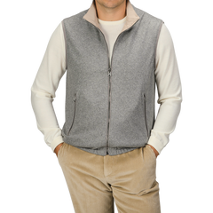 A person wearing a Manto Grey Beige Cashmere Nylon Reversible Gilet over a white long-sleeve shirt and beige corduroy pants stands against a plain background.