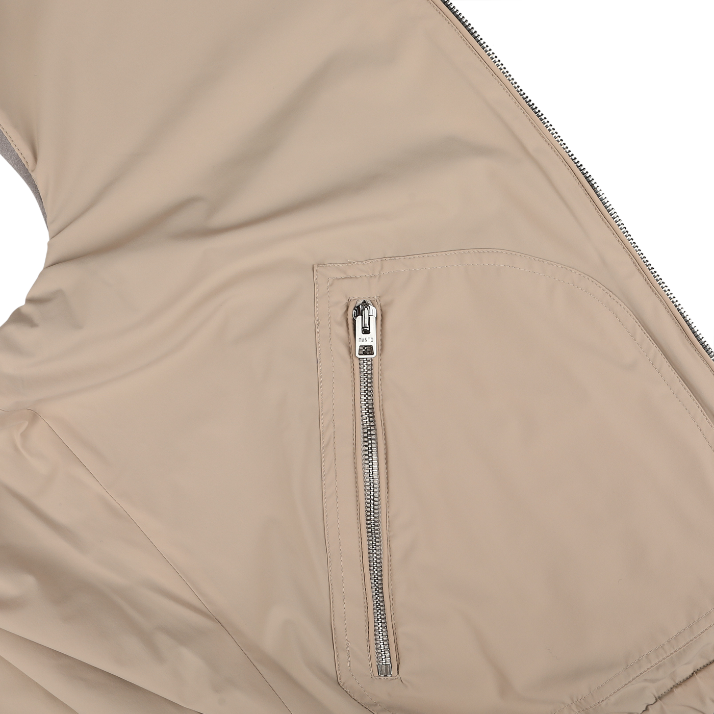 Close-up of the Manto Grey Beige Cashmere Nylon Reversible Gilet showcasing a zippered pocket with a metal zipper and a white pull tag. The gilet's fabric appears smooth and slightly shiny.