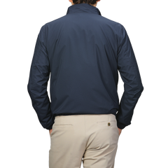 The person, facing away, is dressed in a Manto Navy Beige Reversible Nylon Blouson paired with beige pants.