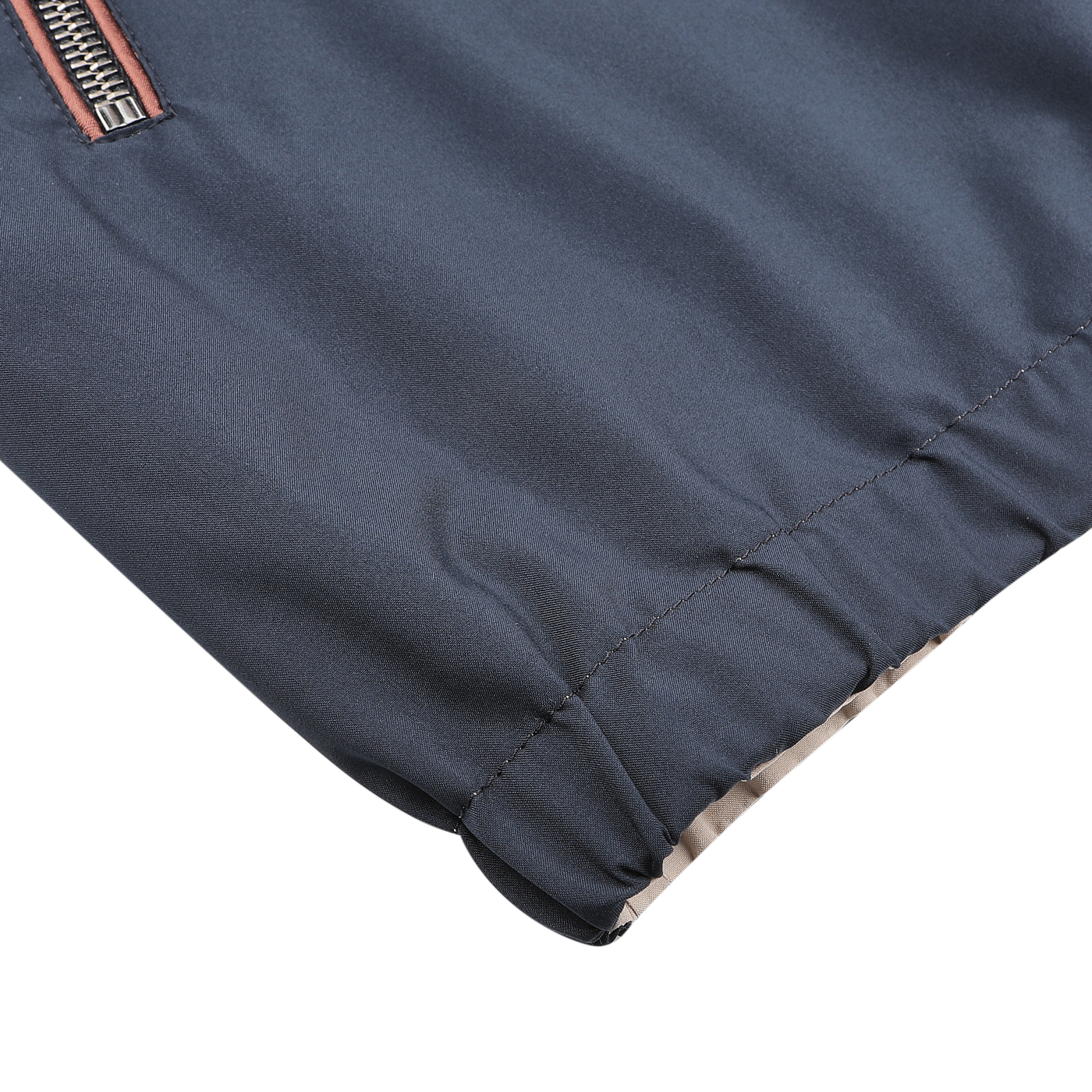 A close-up of the Navy Beige Reversible Nylon Blouson by Manto showcases its gray, water-resistant nylon fabric with a zipper and elastic hem for a sleek, slim fit look.