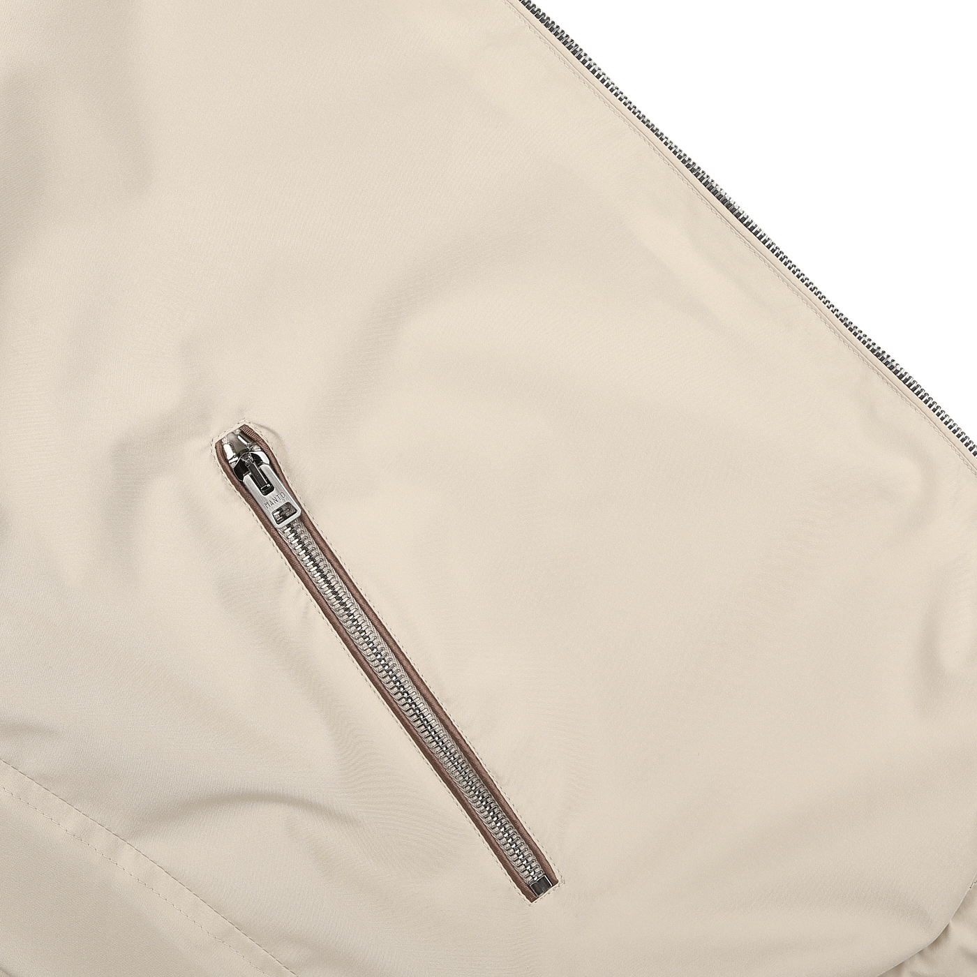 Close-up of Manto's water-resistant Navy Beige Reversible Nylon Blouson featuring a diagonal zipper pocket, showcasing its sleek design.