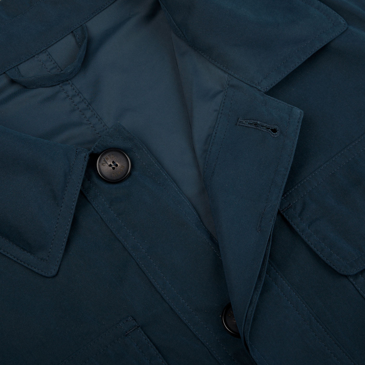 A close up of a Manto Navy Blue Ultrafine Microfiber Safari Jacket with buttons.