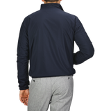 A man is shown from the back, standing against a plain gray background, wearing Manto's Navy Grey Cashmere Nylon Reversible Blouson and light gray pants.