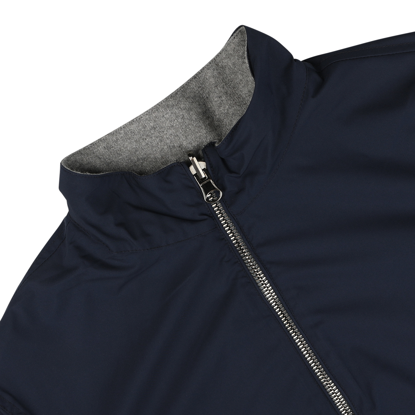 Close-up view of the Navy Grey Cashmere Nylon Reversible Blouson by Manto, featuring a dark blue exterior, a full front zipper, and a high collar that reveals its grey lining inside.