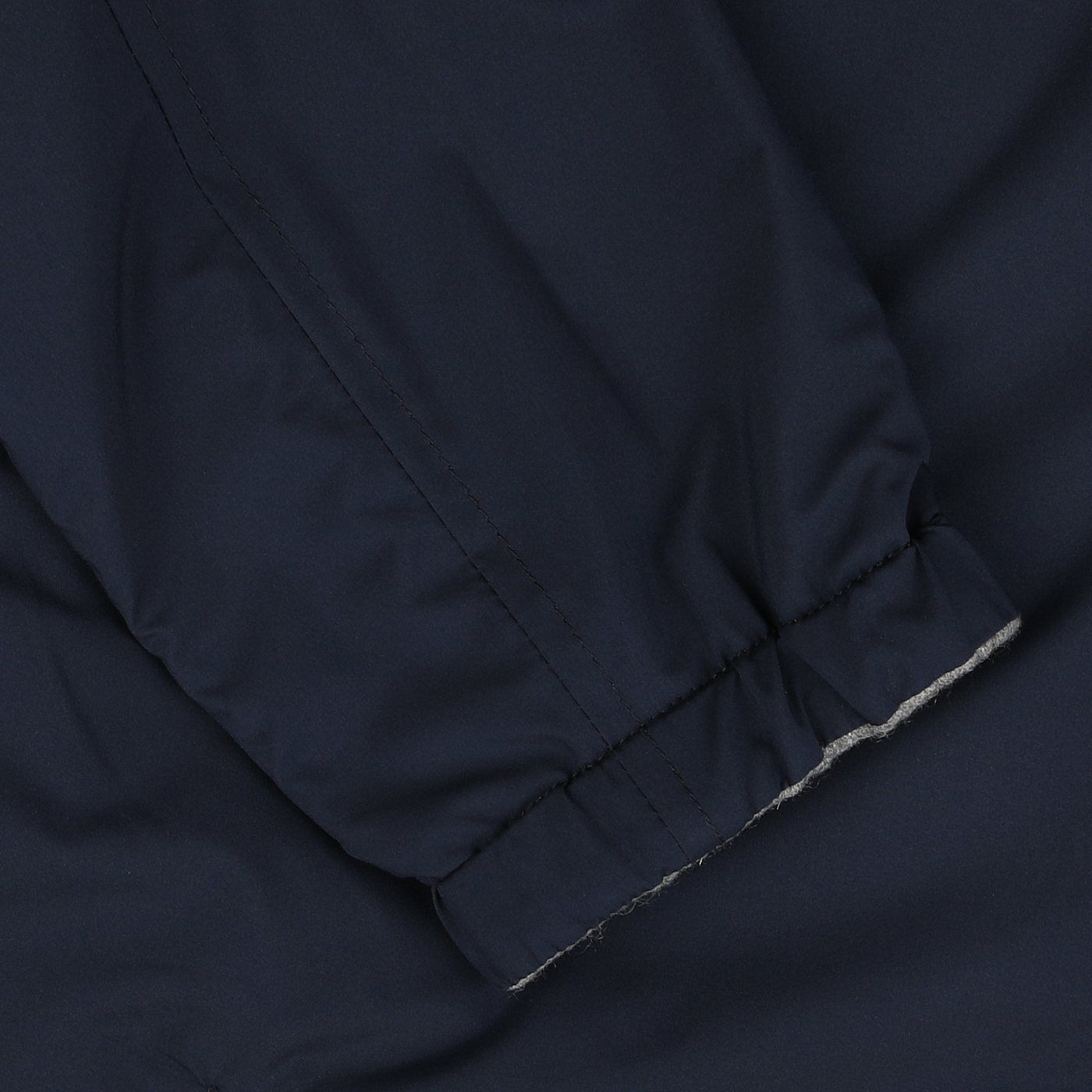 Close-up of the sleeve of the Manto Navy Grey Cashmere Nylon Reversible Blouson, highlighting the elastic cuff and intricate stitching details.