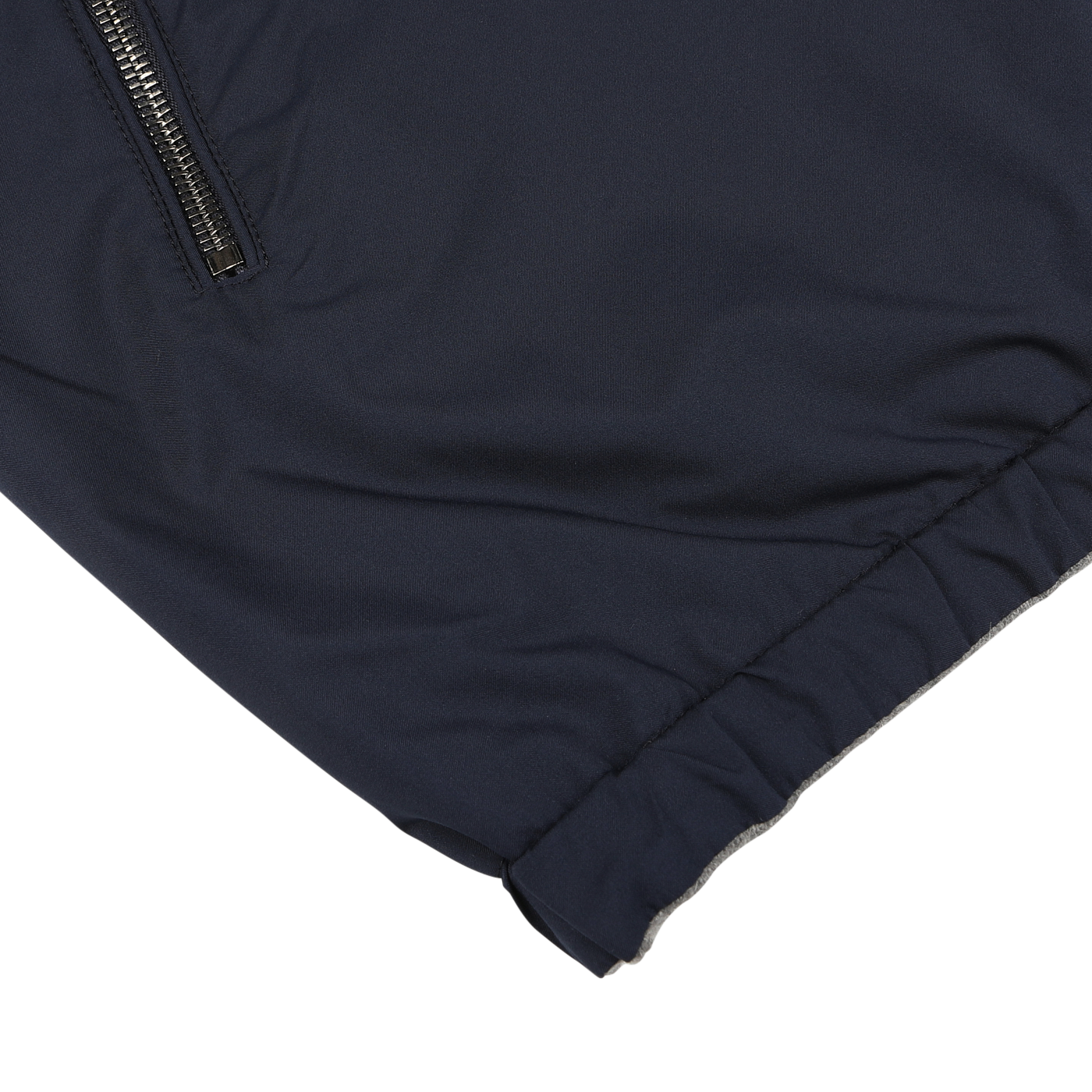 Close-up of the Manto Navy Grey Cashmere Nylon Reversible Blouson, showcasing a zippered pocket and an elasticized hem.