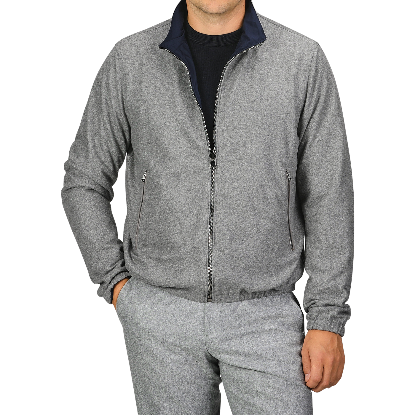 A person is wearing a Manto Navy Grey Cashmere Nylon Reversible Blouson over a black shirt and matching grey pants, with their left hand in the pocket.