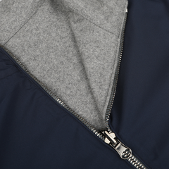 Close-up image of a partially unzipped Navy Grey Cashmere Nylon Reversible Blouson by Manto, revealing a gray cashmere lining.