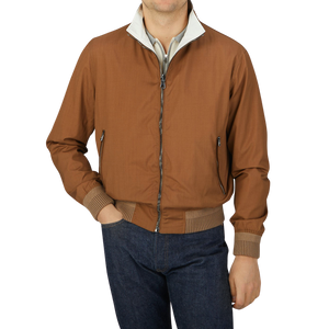 A man wearing a Manto Tobacco Reversible Loro Piana Wool Silk Blouson bomber jacket.