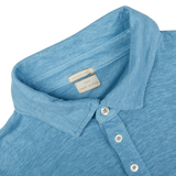 Close-up of a light blue Massimo Alba Aqua Blue Linen Polo Shirt collar with a tag and buttons.