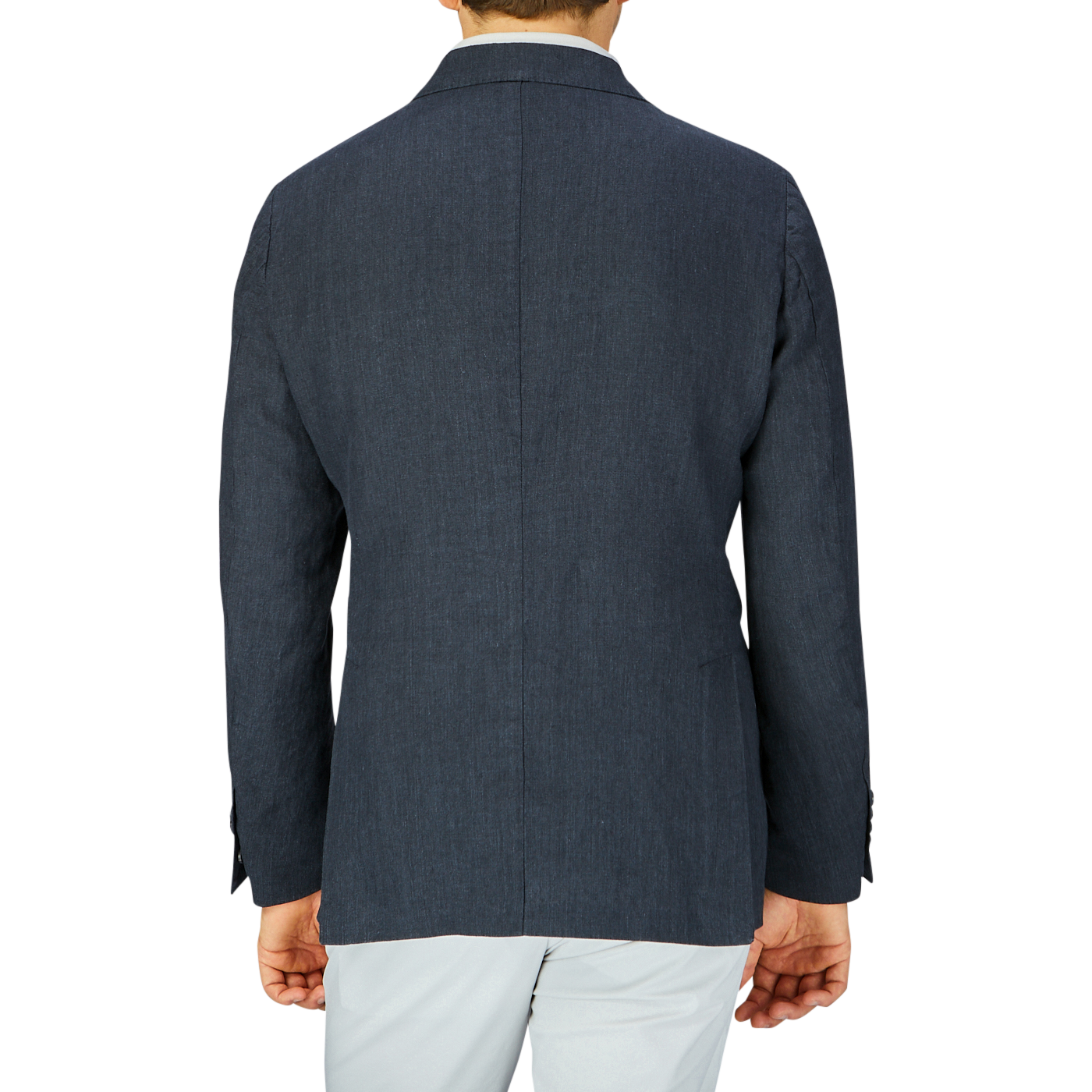 Rear view of a person wearing a Massimo Alba Black Washed Linen Unstructured Blazer in dark blue and white pants.