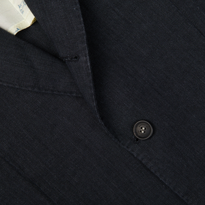 Close-up of a black button on a dark, Massimo Alba Black Washed Linen Unstructured Blazer.