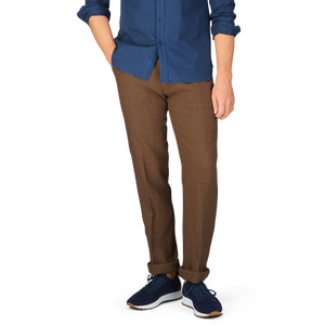 Lower body of a person dressed in Massimo Alba Light Brown Linen Casual Trousers made in Italy, and blue sneakers, with the upper body cropped out of the image.