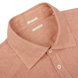 Close-up of a Peach Orange Striped Cotton Linen Genova shirt from Massimo Alba with a buttoned collar and a visible label.
