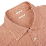 Close-up of a Peach Orange Striped Cotton Linen Genova shirt from Massimo Alba with a buttoned collar and a visible label.