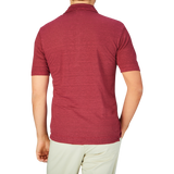 A man viewed from behind, wearing a Massimo Alba Raspberry Red Linen Polo Shirt and light-colored pants.